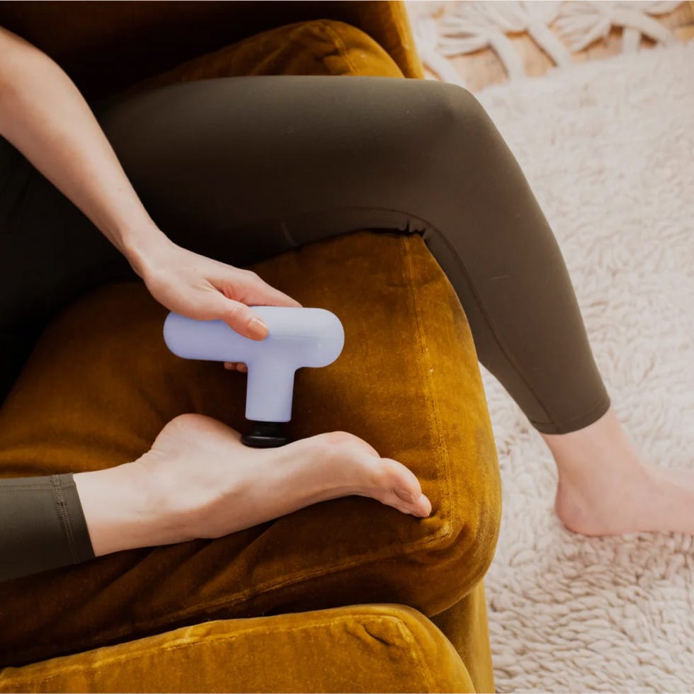 a person using a massage gun on their foot