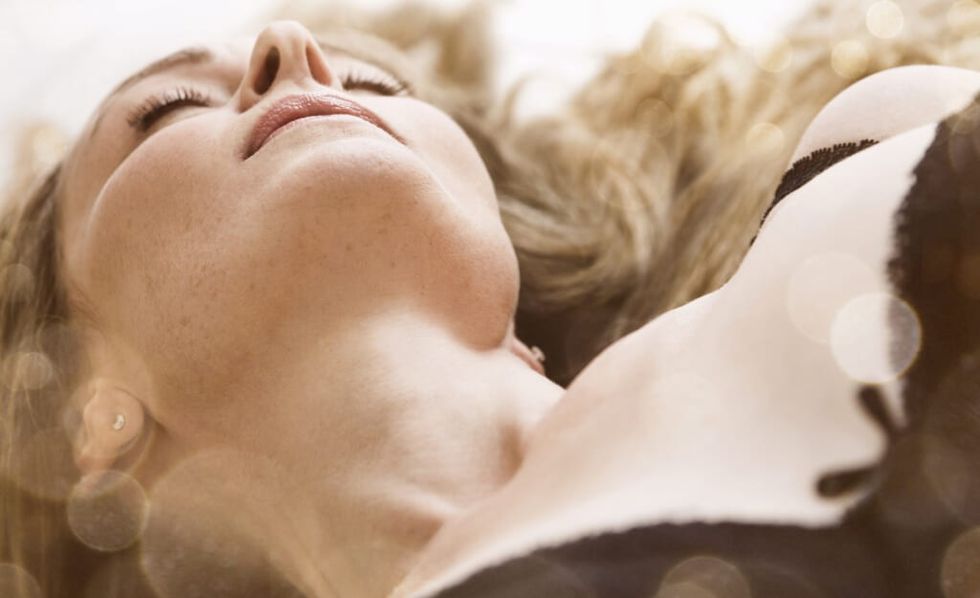 woman in lingerie resting with eyes closed