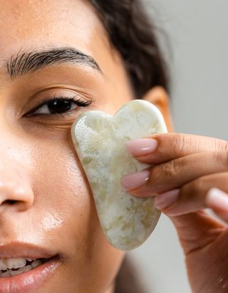 Woman using a gua sha